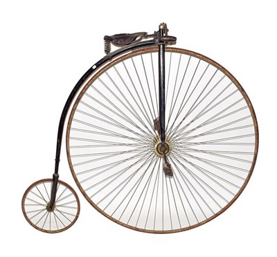Lot 243 - ~ A Late 19th Century Penny Farthing Bicycle, with black painted frame, leather sprung seat, wooden
