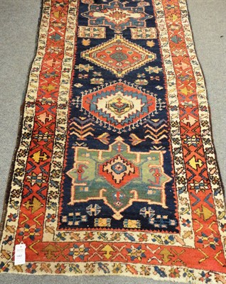 Lot 1467 - Heriz Runner Persian Azerbaijan The deep indigo field with a column of polychrome medallions...