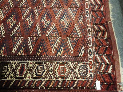 Lot 1470 - Yomut Carpet  West Turkestan The chestnut field with columns of Dyrnak guls enclosed by ivory...