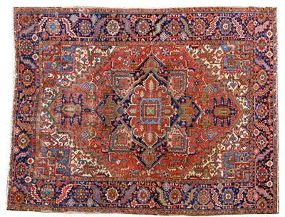 Lot 1473 - Heriz Carpet  Persian Azerbaijan The stepped madder field centred by an indigo medallion surrounded