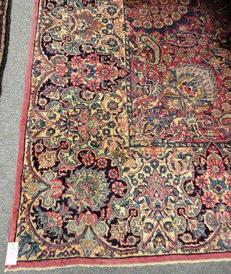 Lot 1479 - Kirman Carpet  South East Persia The claret field richly decorated with flowering plants and...