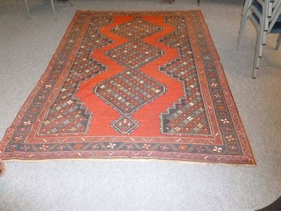 Lot 1488 - Karabagh Rug South Caucasus The plain madder field with triple linked stepped medallions containing