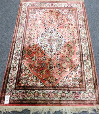 Lot 1489 - A Very Finely Woven Ghom Silk Rug Central Persia The pale strawberry field of scrolling floral...