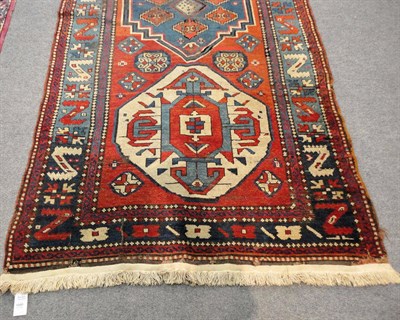 Lot 1495 - Kazak Rug  Central Caucasus The brick red field centred by a pale blue stepped medallion and...