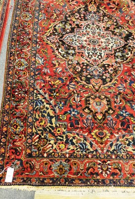 Lot 1499 - Bakhtiari Rug  West Persia The strawberry field of brightly flowering vines around an ivory and...