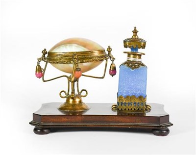 Lot 9 - A Gilt-Metal Mounted Blue-Glass Scent-Bottle, mounted on a wood base with a gilt-metal mounted...