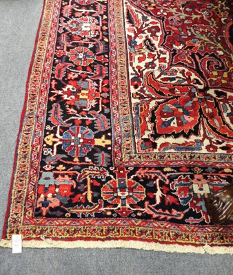 Lot 1512 - Heriz Carpet Persian Azerbaijan The claret field of floral vines around a typical medallion...