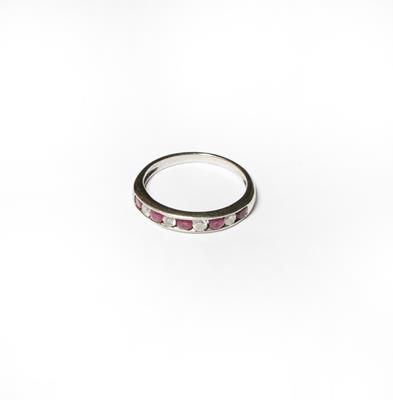 Lot 195 - An 18 carat white gold ruby and diamond half hoop ring, finger size L1/2