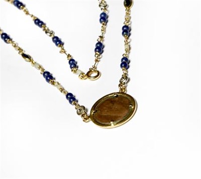 Lot 206 - A sapphire, diamond and blue bead necklace with a hammered coin centrally, length 50cm
