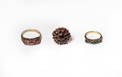 Lot 207 - A 9 carat gold garnet cluster ring, finger size M; a 9 carat gold sapphire five stone ring,...