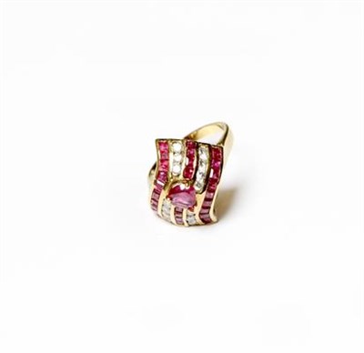 Lot 225 - A synthetic ruby and diamond ring, a pear cut synthetic ruby set above five rows of alternating...