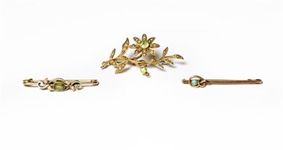 Lot 228 - A peridot and split pearl brooch, the floral spray set throughout with two round cut peridots...