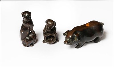 Lot 237 - Two Japanese carved wooden netsukes in the form of dogs (both signed) and another of a pig