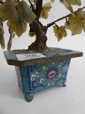 Lot 250 - A Chinese cloisonne planter with hardstone tree