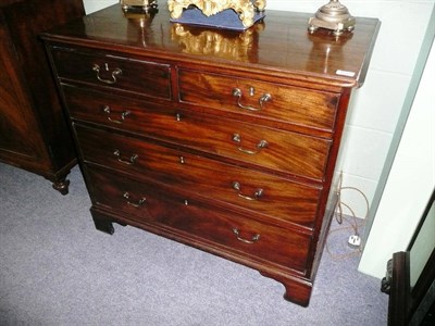 Lot 1531 - A George III Mahogany Straight Front Chest, early 19th century, of two short over three long...