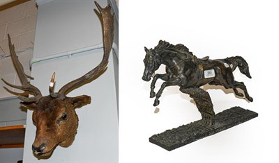 Lot 260 - A bronzed and resin figure of a racehorse, together with a taxidermy specimen of a deer head (2)