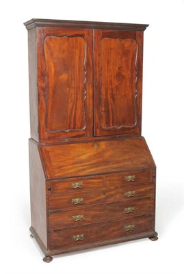 Lot 1534 - A George III Mahogany Bureau Bookcase, by Philip Bell, London, circa 1770, with two cupboard...