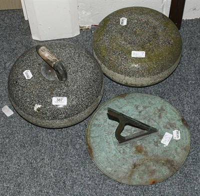 Lot 387 - Two curling stones (one handle lacking), together with a sundial (3)