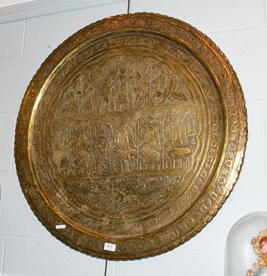 Lot 411 - A Persian brass charger depicting Darius the Great, 80cm diameter