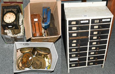 Lot 426 - A quantity of clock movements, watchmakers cabinet of small drawers, electric tower clock motor etc