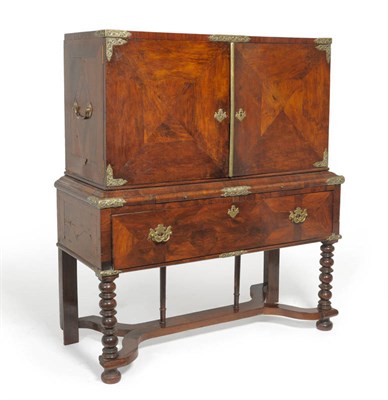 Lot 1551 - A Late 17th Century Walnut Cabinet on Stand, with quarter-veneered cupboard doors enclosing an...