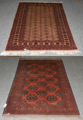 Lot 1205 - An Afghan Turkman rug, the brick red field with columns of panels enclosed by multiple narrow...