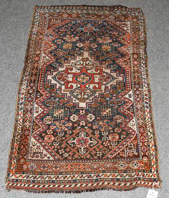 Lot 1206 - A Kashgai rug, the field of tribal motifs around an ivory medallion framed by spandrels and...