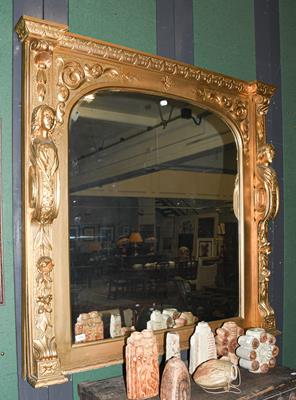 Lot 1242 - A gilt framed over mantle mirror, the frame carved with caryatids, 127cms by 131cms