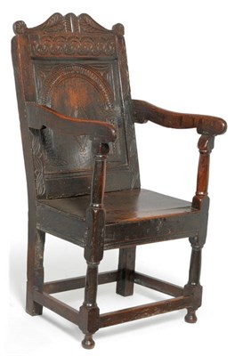 Lot 1574 - A Joined Oak Wainscot Chair, 17th century in part, with carved back panel above a boarded seat, gun