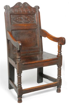 Lot 1576 - A Joined Oak Yorkshire Wainscot Armchair, with carved and fielded back support between moulded...