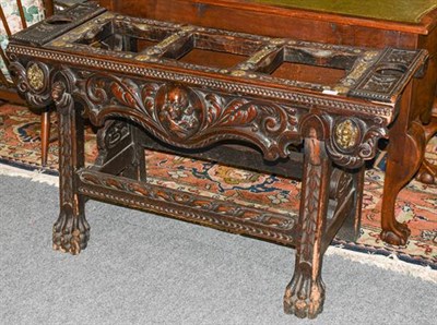 Lot 1275 - A 19th century carved oak counter table, of rectangular form, with brass rosette motifs and...