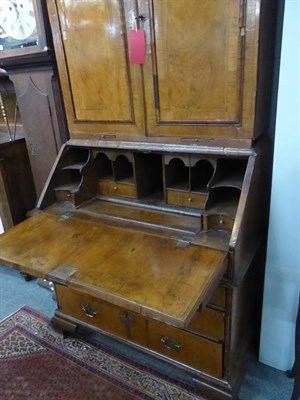 Lot 1277 - An early 18th century walnut bureau bookcase, the upper section with moulded panel doors...
