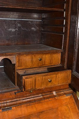 Lot 1277 - An early 18th century walnut bureau bookcase, the upper section with moulded panel doors...