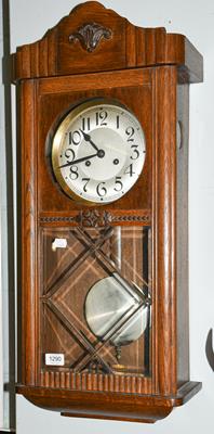 Lot 1290 - An Art Deco oak veneered striking drop dial wall clock
