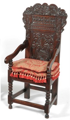 Lot 1579 - A Joined Oak Wainscot Type Chair, 19th century, the carved back support above fielded panels...