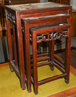 Lot 1304 - A set of three early 20th century Chinese hardwood nesting tables, of rectangular form, the moulded