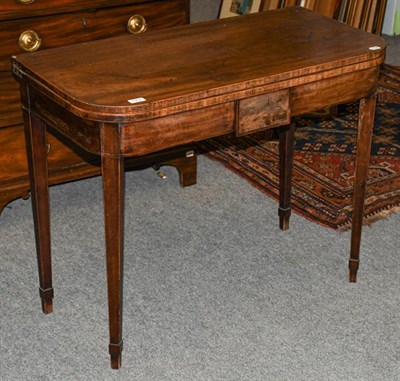 Lot 1317 - A George III crossbanded mahogany fold over tea table, 92cm by 45cm by 73cm