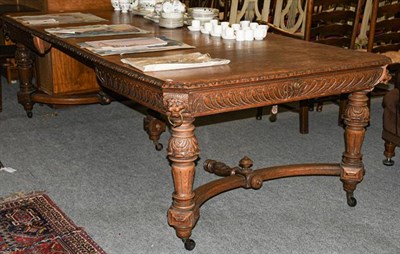 Lot 1320 - A Victorian carved oak wind-out dining table with two additional leaves, 245cm by 122cm by 74cm