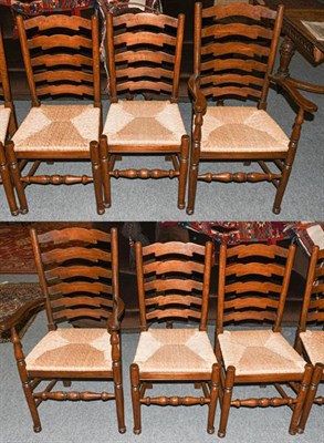 Lot 1324 - A set of six oak ladder back rush seated dining chairs, including two carvers (6)