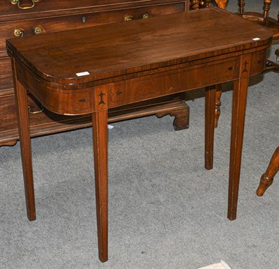 Lot 1343 - A George III mahogany fold over tea table with ebonised stringing, 89cm by 43cm by 74cm
