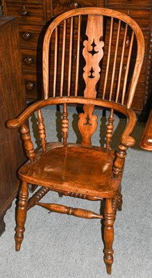 Lot 1345 - A 19th century elm and yew Windsor armchair with twin stretcher