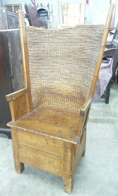 Lot 1585 - A Late 19th Century Joined Pine Orkney Chair, with curved rush back and wings, the boarded seat...