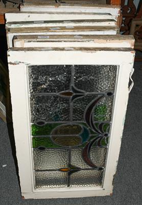 Lot 1379 - A set of six leaded and coloured glass windows in white painted frames, circa 1900/1910, each...