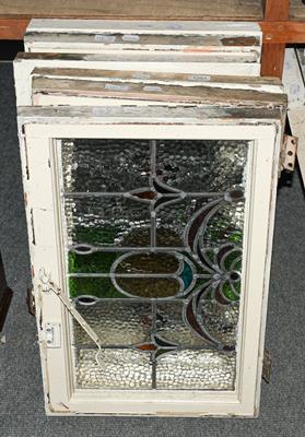 Lot 1381 - A set of six leaded and coloured glass windows in white painted frames, circa 1900/1910, each...