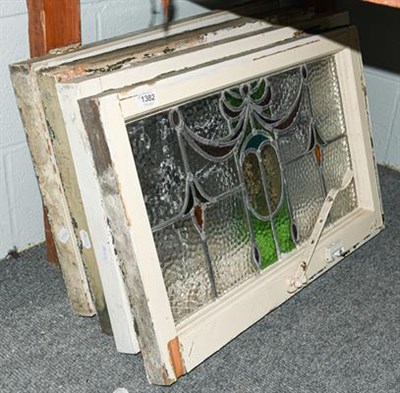 Lot 1382 - A set of four leaded and coloured glass windows in white painted frames, circa 1900/1910, each 43cm