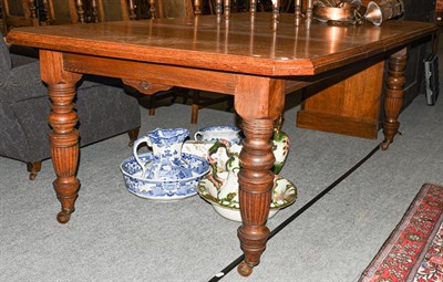 Lot 1387 - A Victorian oak wind-out dining table with two additional leaves, 243cm (open) by 120cm, 74cm high