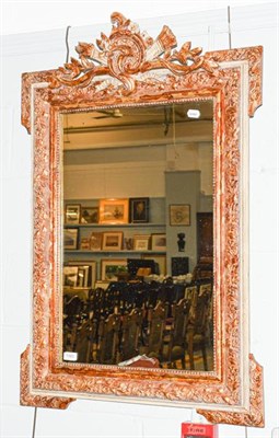 Lot 1393 - A rectangular mirror, the mildly distressed plate within a conforming leaf moulded parcel gilt...
