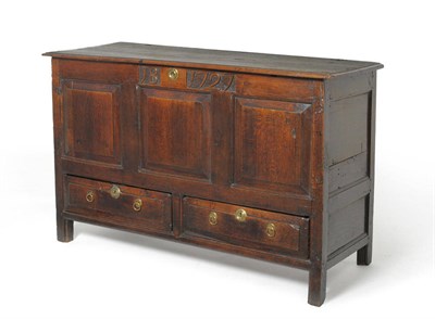 Lot 1589 - An 18th Century Oak Mule Chest, carved with JB 1727, with hinged lid above three fielded panels and