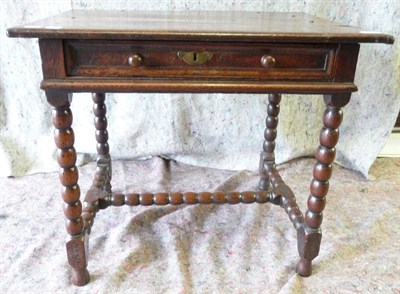 Lot 1593 - A 17th Century Oak Side Table, of three plank construction over a frieze drawer and raised on...