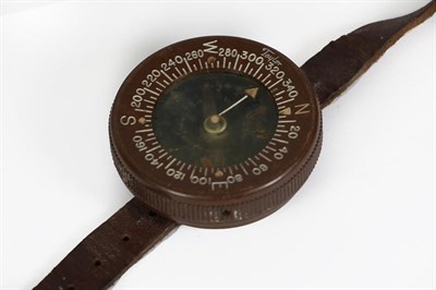 Lot 43 - A US Army Paratrooper's Wrist Compass by Taylor, liquid filled, with bakelite case and leather...